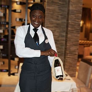 Waitress presenting a bottle of wine at the table