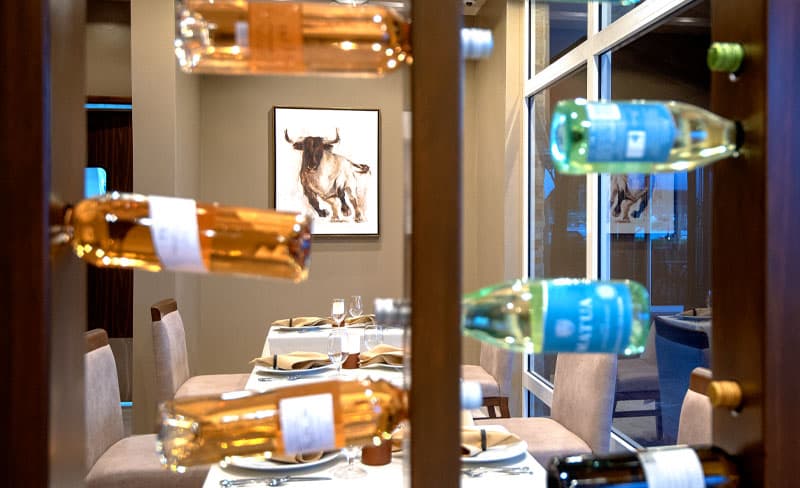 Restaurant interior with wine rack and bull painting